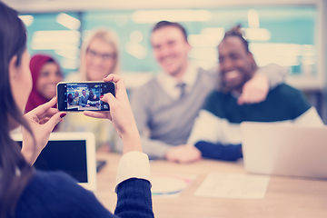 Image showing businesswoman using mobile phone for taking photo