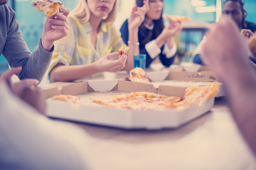 Image showing multiethnic business team eating pizza