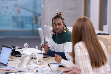 Image showing multiethnic business team learning about drone technology