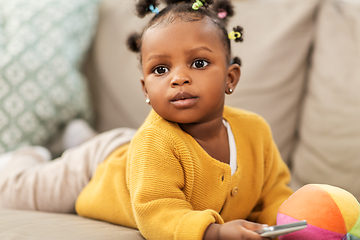 Image showing african american baby girl with smartphone at home