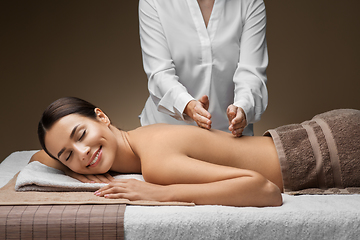 Image showing woman lying and having back massage at spa