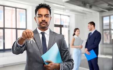 Image showing indian man realtor with keys at empty office room