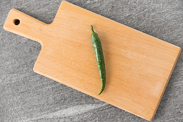 Image showing green chili pepper on wooden cutting board