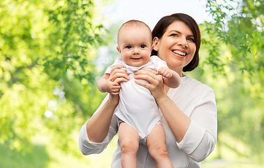 Image showing happy middle-aged mother with little baby daughter