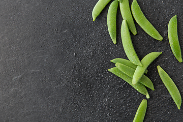 Image showing peas on wet slate stone background