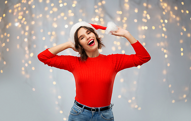 Image showing happy young woman in santa hat on christmas