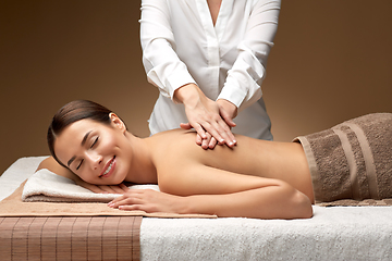 Image showing woman lying and having back massage at spa