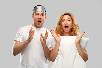 Image showing scared couple with eye sleeping mask and pillow