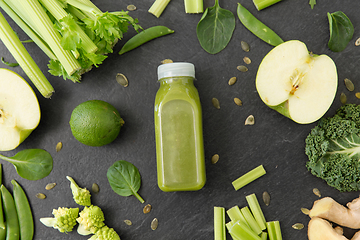 Image showing close up of bottle with green juice and vegetables