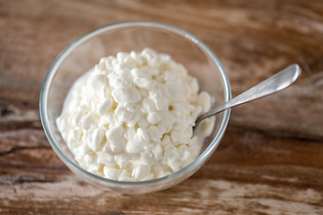 Image showing close up of cottage cheese in bowl on wooden table