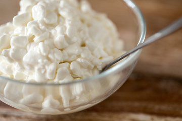 Image showing close up of cottage cheese in bowl on wooden table