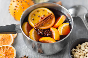 Image showing pot with hot mulled wine, orange slices and spices