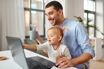 Image showing working father with baby daughter at home office