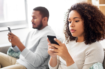 Image showing african american couple with smartphone at home