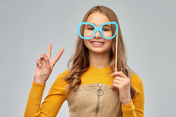 Image showing smiling teenage girl with big glasses