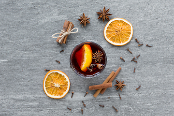 Image showing hot mulled wine, orange slices, raisins and spices