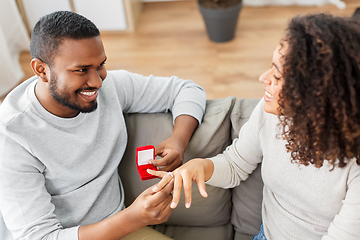 Image showing african american man giving woman engagement ring