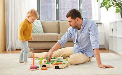 Image showing father playing with little baby daughter at home