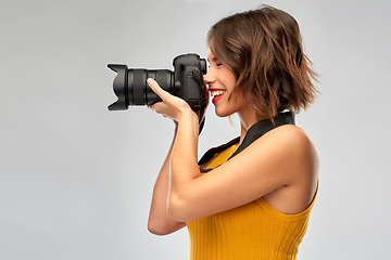 Image showing happy woman photographer with digital camera