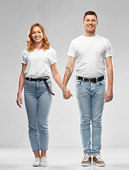 Image showing happy couple in white t-shirts holding hands