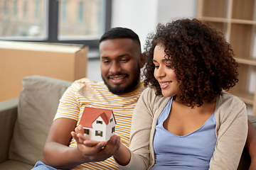 Image showing happy couple with house model moving to new home