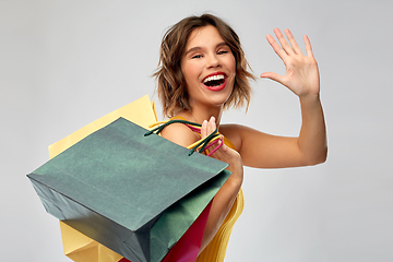 Image showing happy smiling young woman with shopping bags