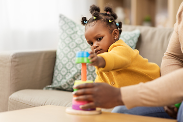 Image showing african family playing with baby daughter at home