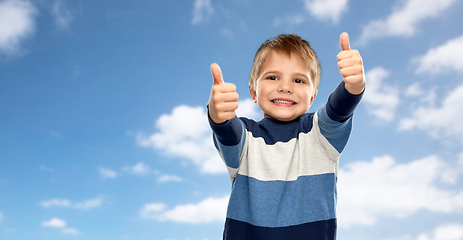 Image showing little boy in striped pullover showing thumbs up