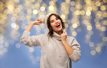 Image showing young woman in winter hat and sweater on christmas