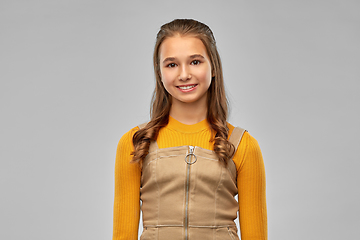 Image showing smiling teenage girl over grey background