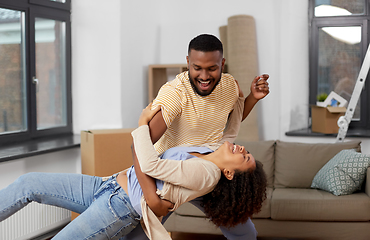 Image showing happy couple moving to new home and dancing