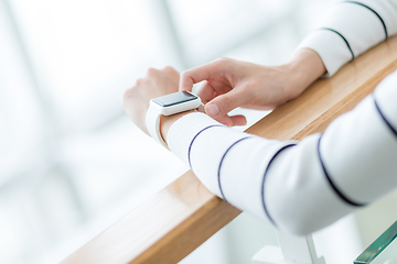 Image showing Woman touch on the screen of smart watch