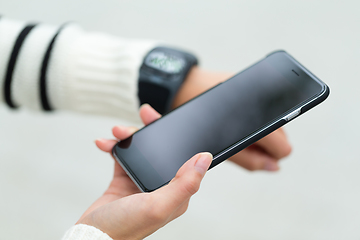 Image showing Woman use of cellphone and connecting smartwatch