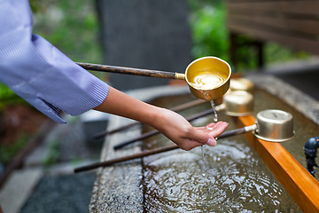 Image showing Woman washing hand in japanese temple