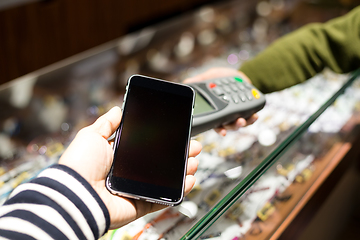 Image showing Woman paying with NFC technology