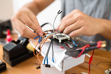 Image showing Man connecting the component of the drone