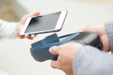 Image showing Woman using cellphone for payment