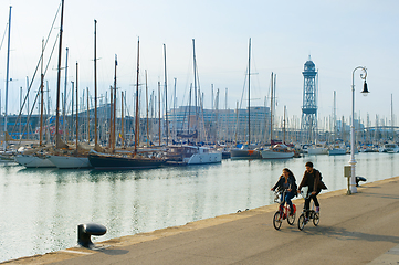 Image showing Couple riding bikes. Barcelona, Spain