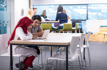 Image showing black muslim business woman having a meeting with her indian mal