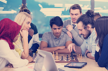 Image showing multiethnic group of business people playing chess