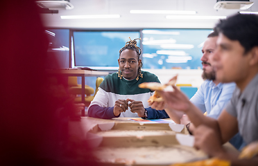 Image showing multiethnic business team eating pizza