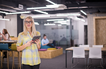 Image showing blonde businesswoman working online using digital tablet