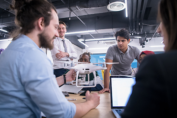 Image showing multiethnic business team learning about drone technology