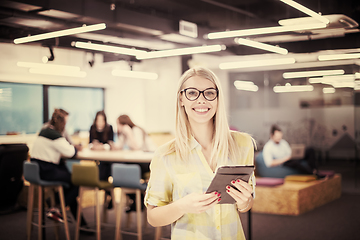 Image showing blonde businesswoman working online using digital tablet