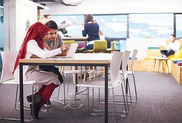 Image showing black muslim business woman having a meeting with her indian mal