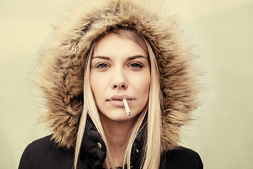 Image showing portrait of young blonde girl with cigarette in the mouth