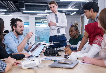 Image showing multiethnic business team learning about drone technology