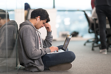 Image showing software developer working on the floor