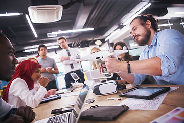 Image showing multiethnic business team learning about drone technology