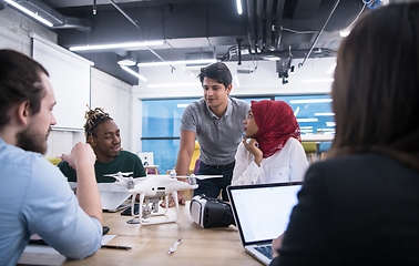 Image showing multiethnic business team learning about drone technology